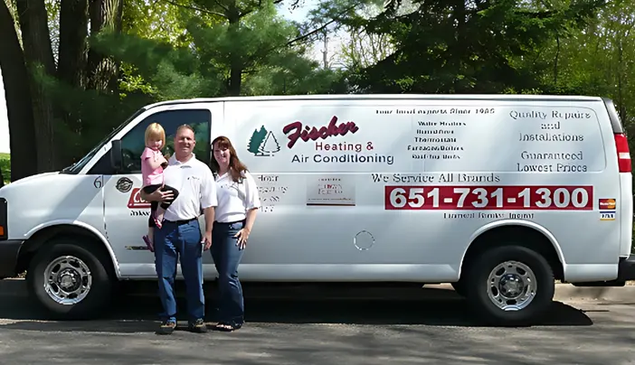 A family standing in front of a white van.